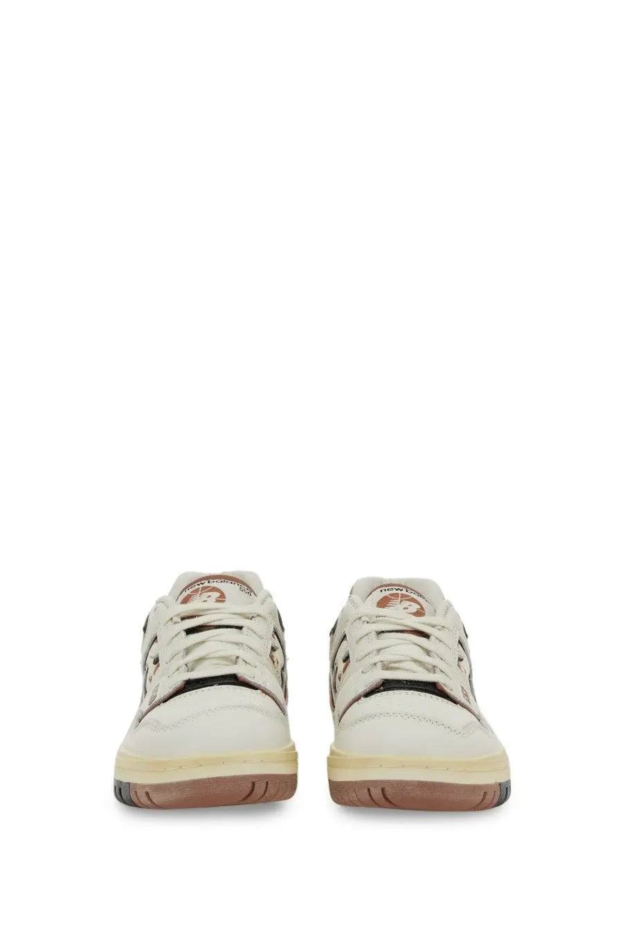 New Balance unisex sneaker white cream leather with brown rubber soles and black accents in a minimalist design