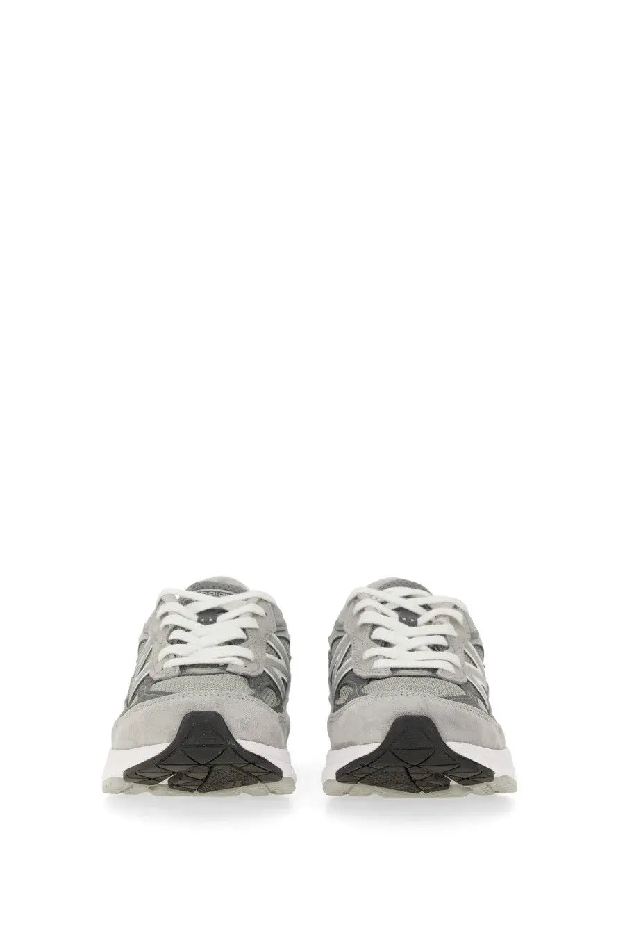 New balance women’s sneaker grey featuring gray and black 990v3 design with white laces and textured rubber sole