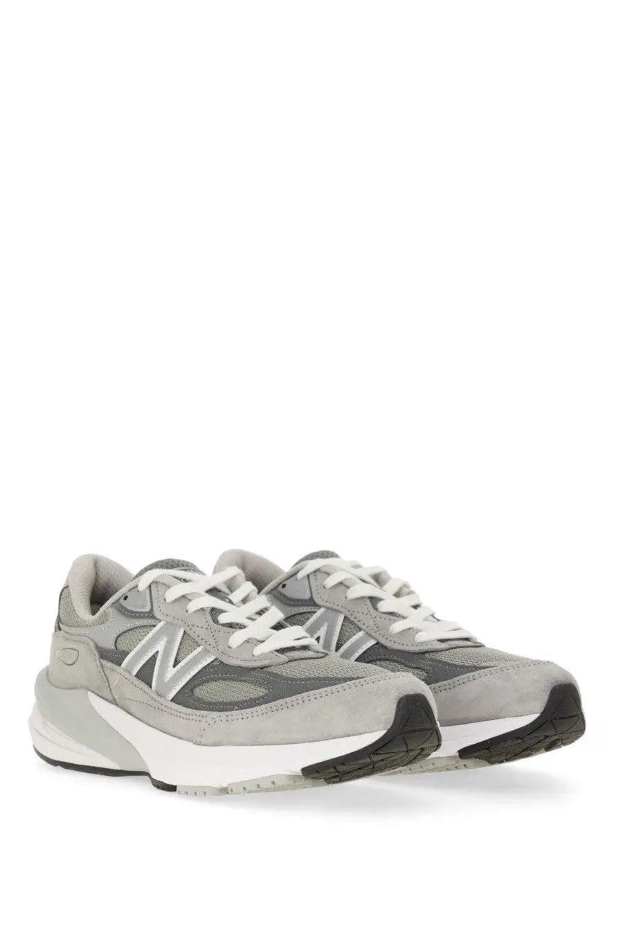 New balance women’s sneaker grey featuring gray suede and mesh with white laces and black rubber outsole