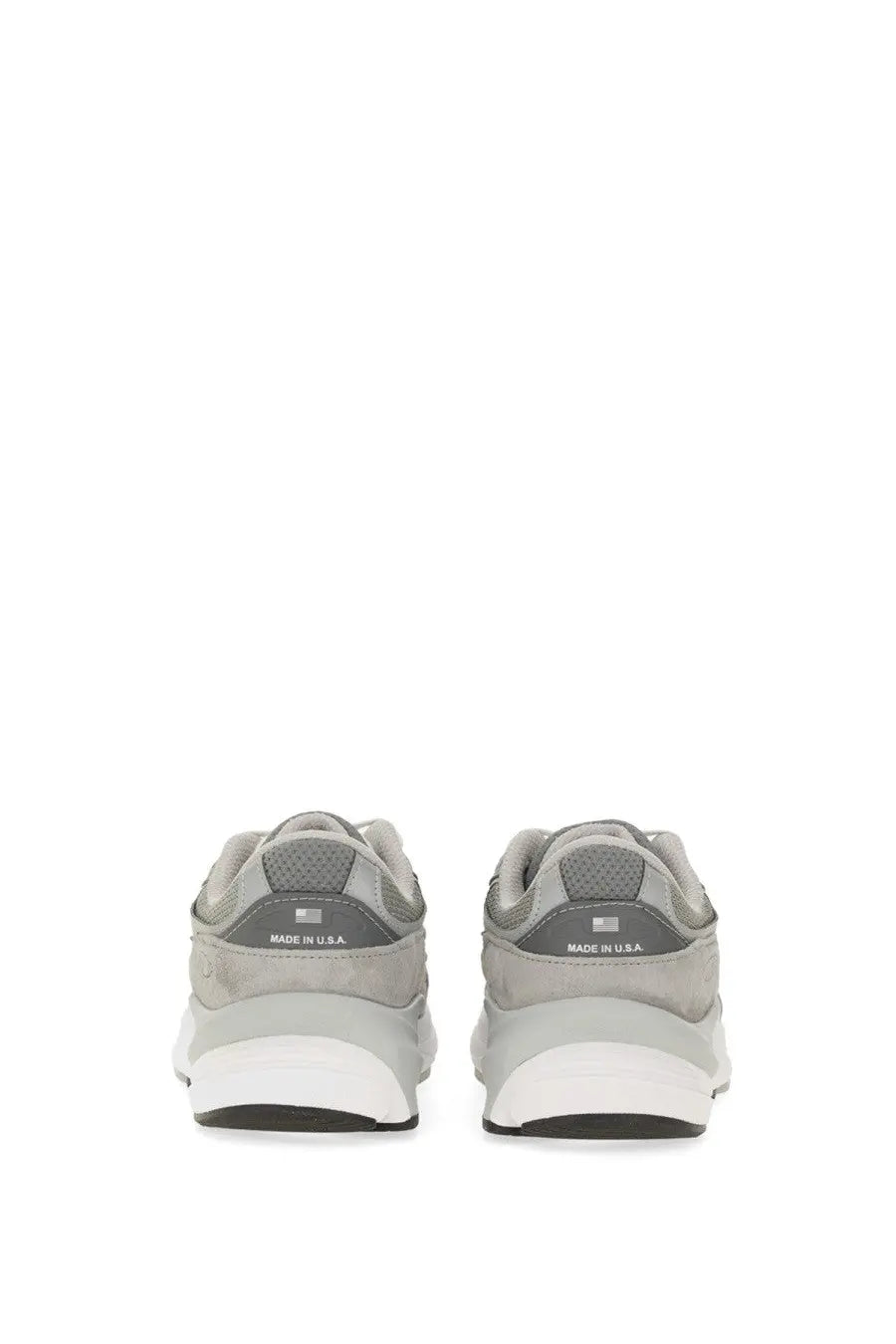 Back view of new balance women’s sneaker grey in gray suede and mesh with white rubber sole and made in usa branding on heel