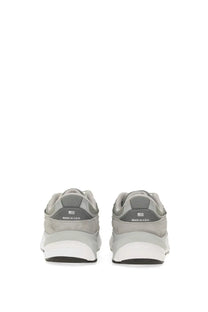 Back view of new balance women’s sneaker grey in gray suede and mesh with white rubber sole and made in usa branding on heel