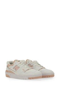 New Balance women’s sneaker white cream-colored 560 with soft pink accents on logo laces and sole