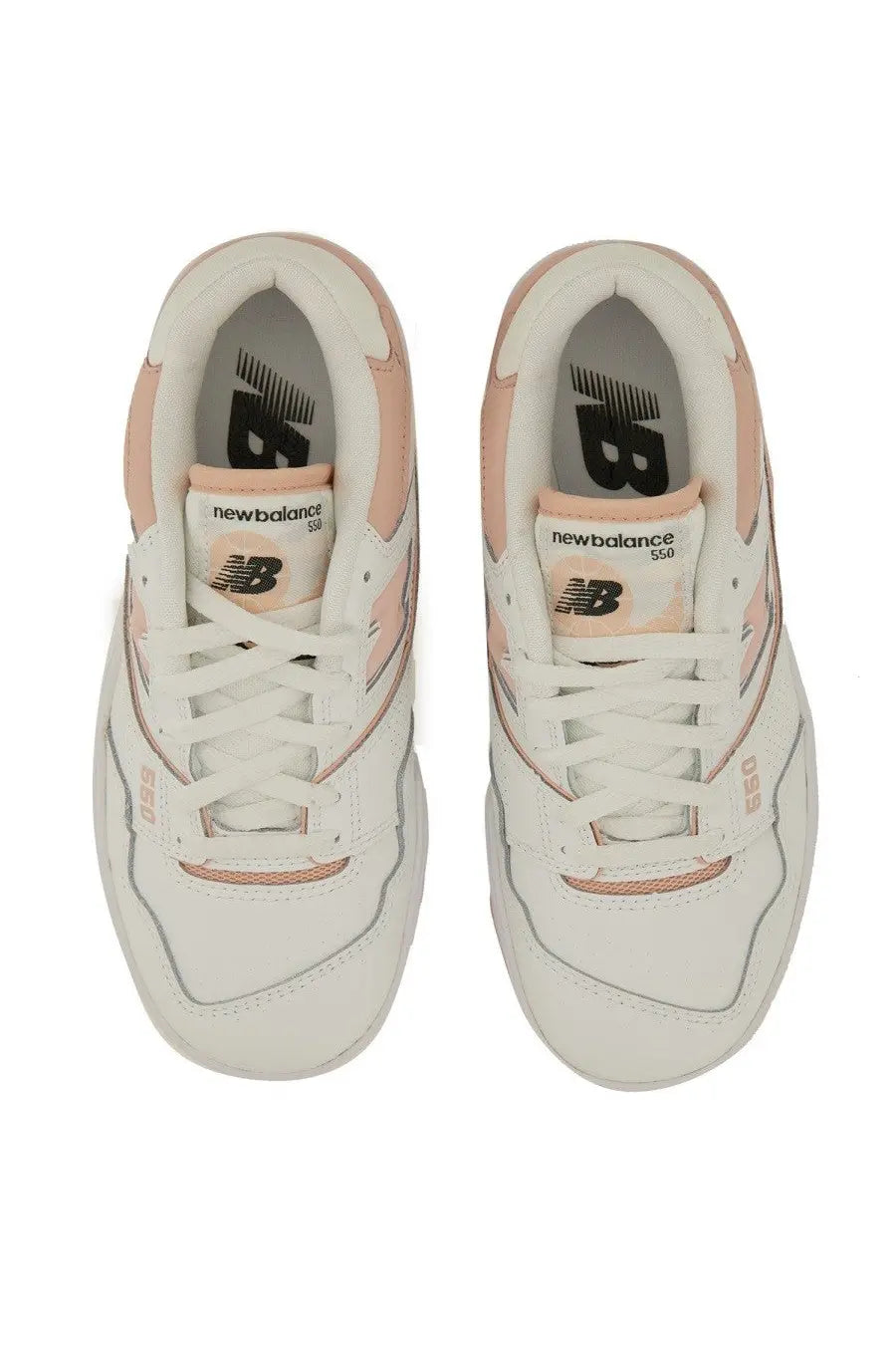 New Balance women’s sneaker in white and blush pink leather with matching suede accents displayed side by side