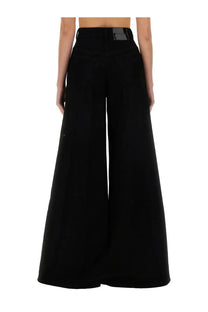 Black high-waisted wide-leg tailored trousers with subtle brand label at waistband by nina ricci womens flared pants