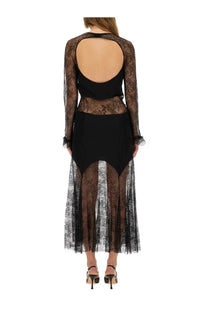 Black lace dress with sheer long sleeves and backless design shown from the back by Nina Ricci women