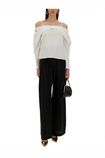 Black leather mini clutch with gold-tone hardware paired with nina ricci women’s off shoulder white shirt