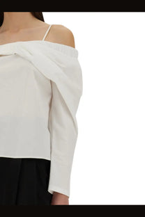 White nina ricci women’s off shoulder blouse with delicate spaghetti straps and soft draped fabric