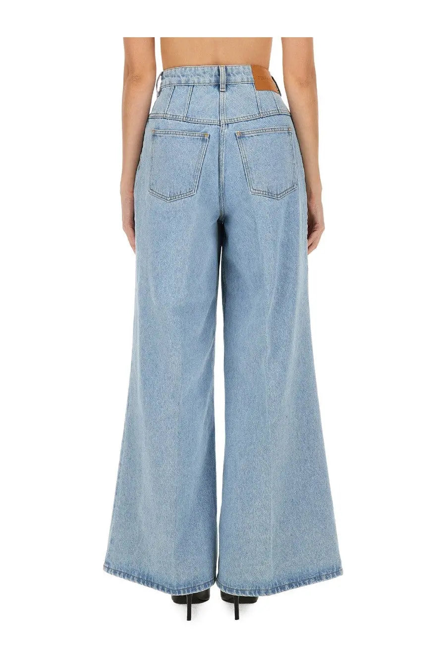 Light-wash denim wide-leg trousers with high waist and classic back pockets shown from the back by nina ricci
