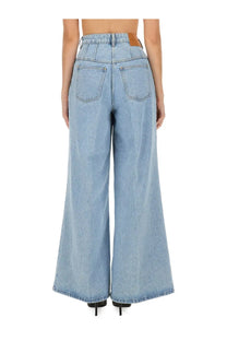 Light-wash denim wide-leg trousers with high waist and classic back pockets shown from the back by nina ricci