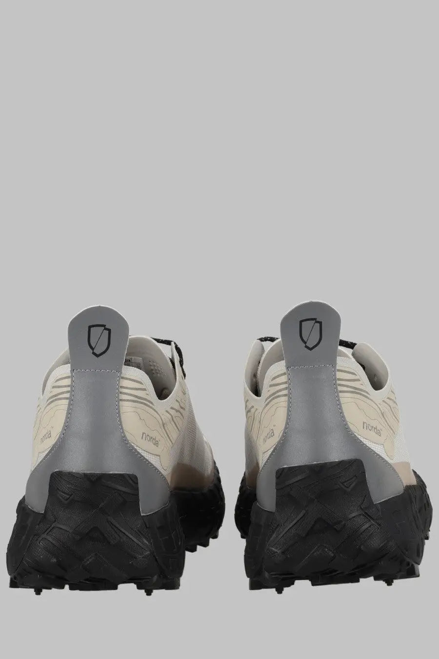 Back view of norda men’s sneaker cinder bio dyneema grey trail running shoe with beige gray rugged sole and shield logo