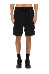 The North Face men’s black cargo shorts with drawstring waistband and multiple pockets featuring logo on thigh