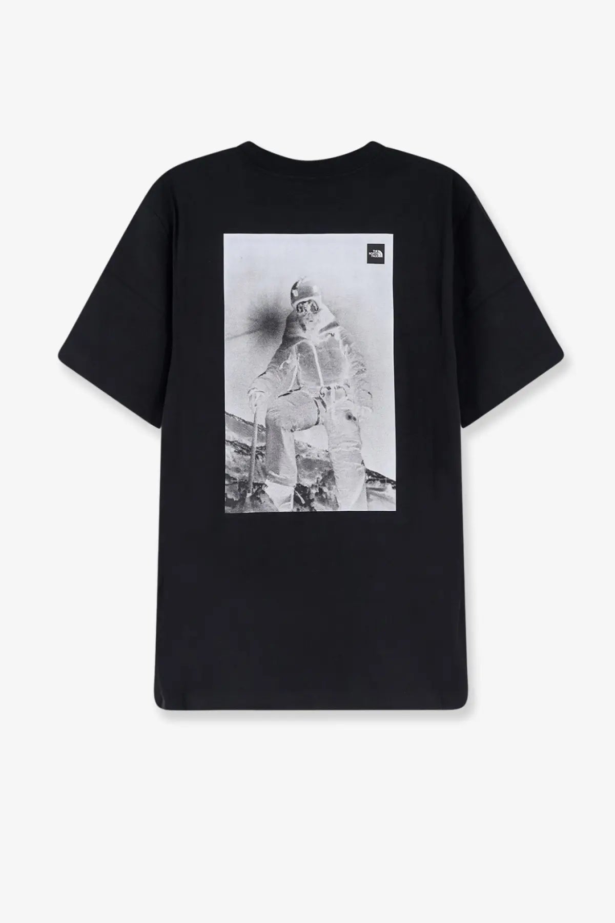 The back of the north face men’s cotton black t-shirt features a grayscale skier graphic and logo in the upper right corner
