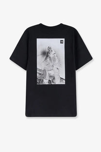 The back of the north face men’s cotton black t-shirt features a grayscale skier graphic and logo in the upper right corner
