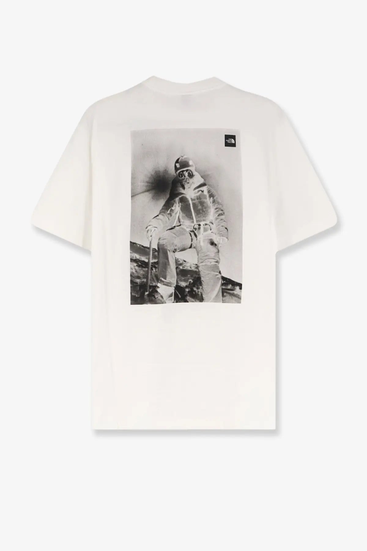 The back of the north face men’s white cotton shirt with a black and white off-white skier graphic on the back