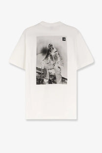 The back of the north face men’s white cotton shirt with a black and white off-white skier graphic on the back