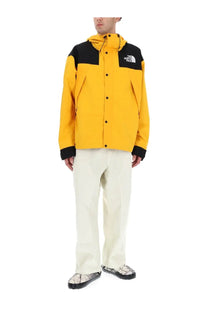 The North Face men’s dryvent jacket yellow with black hood button front and contrasting panels for weather protection