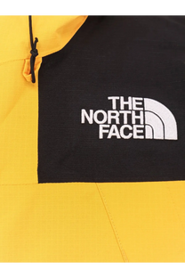 The north face men’s dryvent mono nylon windbreaker jacket in yellow and black with white embroidered logo on chest