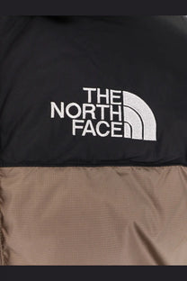The north face men’s himalayan nylon down jacket in black and tan with white embroidered logo is a puffer style