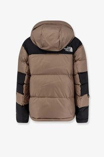 The north face men’s Himalayan brown nylon down jacket features a tan and black quilted puffer design with logo hood