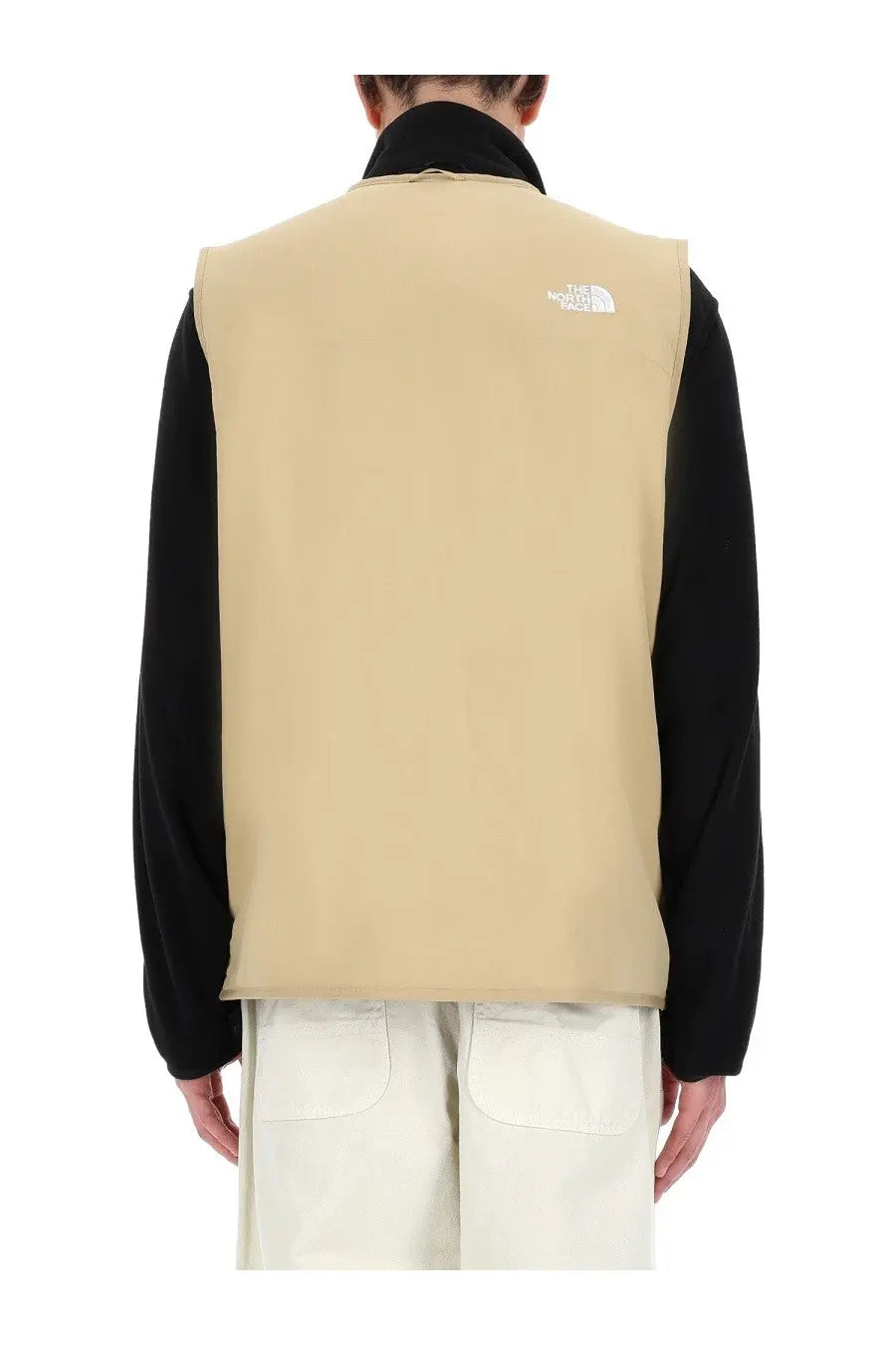 Beige the north face men’s ilti liner vest showing white logo on back side designed for layering and warmth