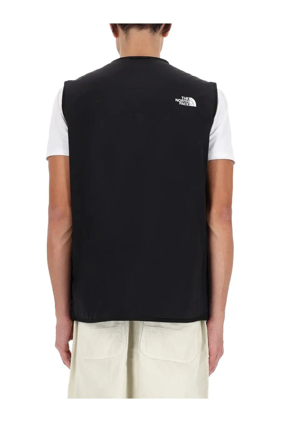 Black the north face men’s ilti liner vest in black showing back side with white logo on upper back