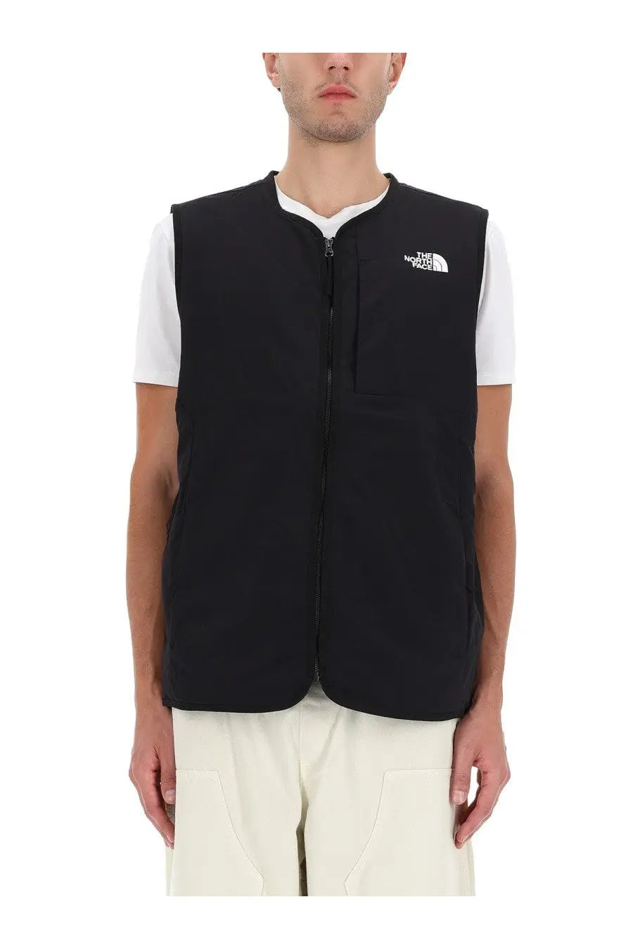The North Face men’s Ilti liner vest in black with a white chest logo and front zipper for lightweight warmth