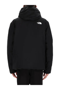 The back side of the north face men’s black hooded jacket features a white logo on the upper back