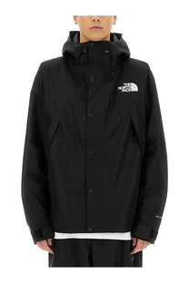 Black the north face men’s hooded jacket with white logo and button closures in mountain black color