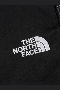 Black the north face jacket with white embroidered logo paired with men’s nylon bermuda shorts in black