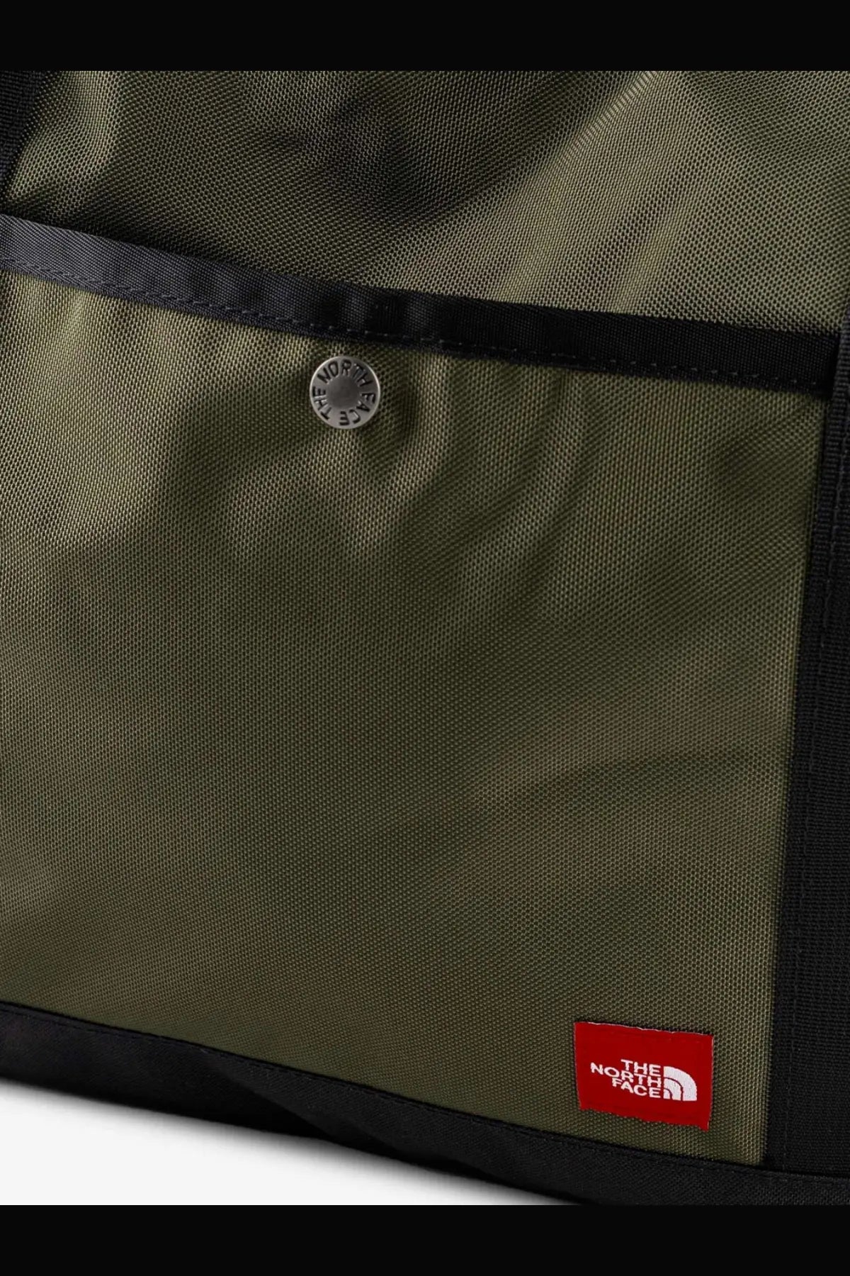 The North Face men’s nylon shoulder bag in beige with olive green canvas, black trim, and a silver snap button