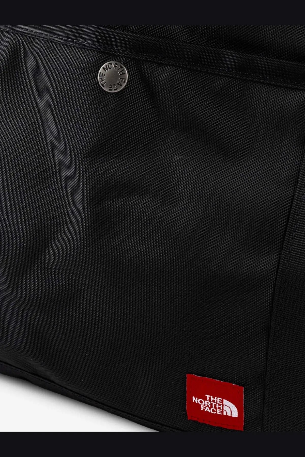 Black the north face men’s nylon shoulder bag with silver button and red brand patch