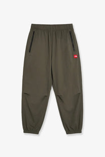 The north face men’s olive green nylon joggers with black zippers and a red brand patch on the thigh