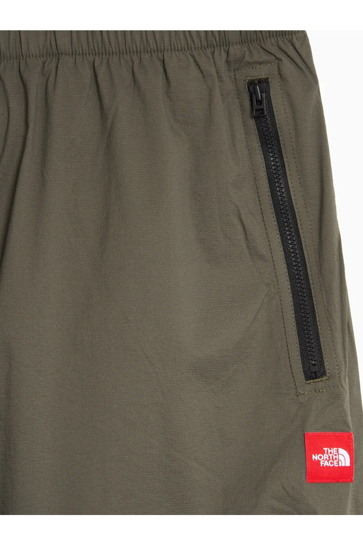 The north face men’s olive green nylon shorts with a black zipper pocket and red brand patch front view