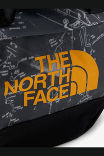 The north face men’s recycled pvc base camp duffel backpack in black with a bold orange logo and white map line art