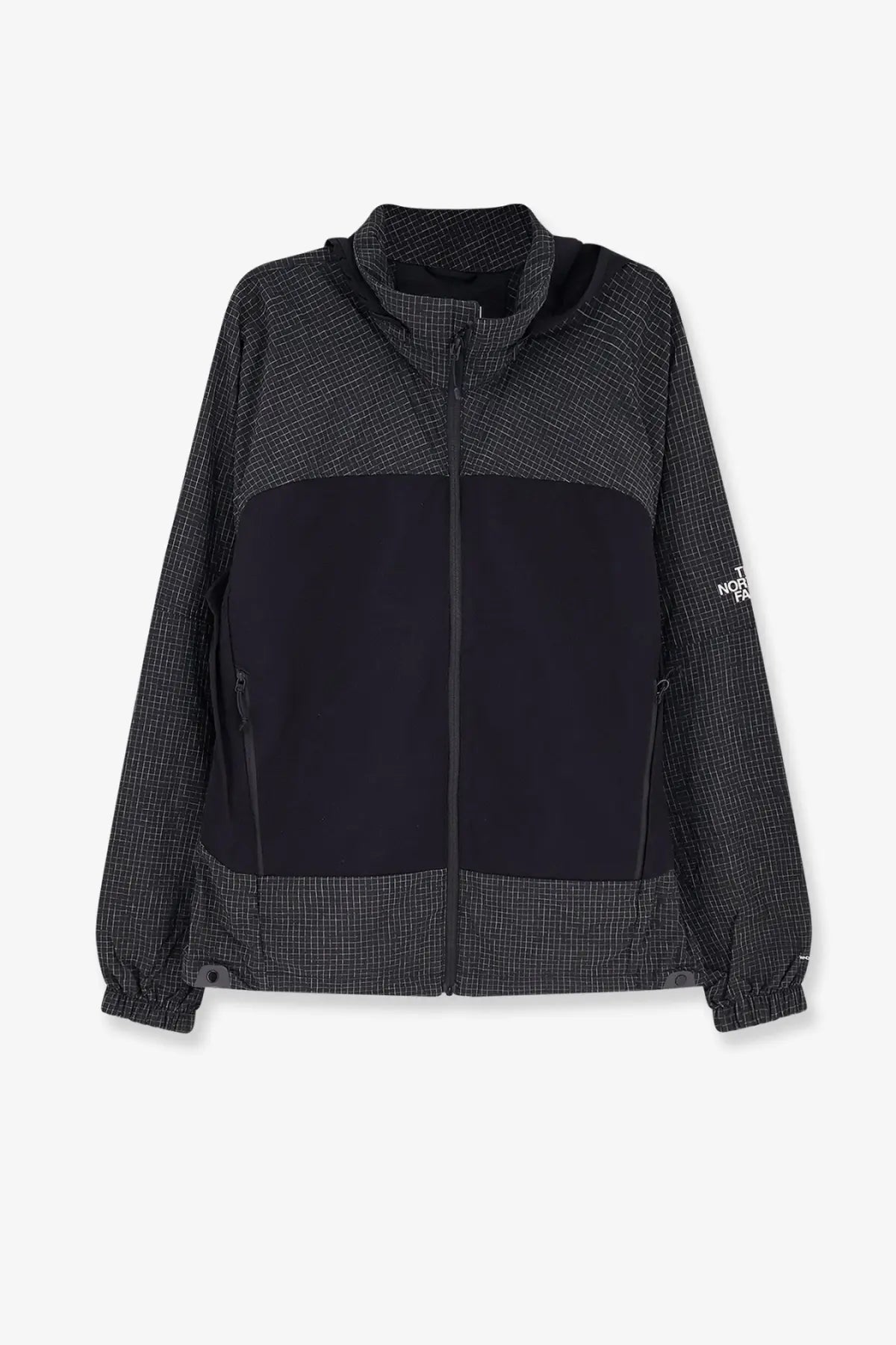 The north face men’s relaxed fit jacket black features a grid pattern upper and lower with solid black midsection and sleeve logo