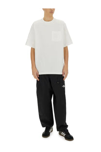The north face men’s relaxed fit white oversized crewneck t-shirt with a single chest pocket for casual wear