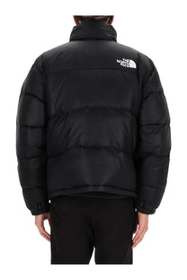 The back of a black the north face men’s retro nuptse puffer jacket with quilted design and white logo on the collar