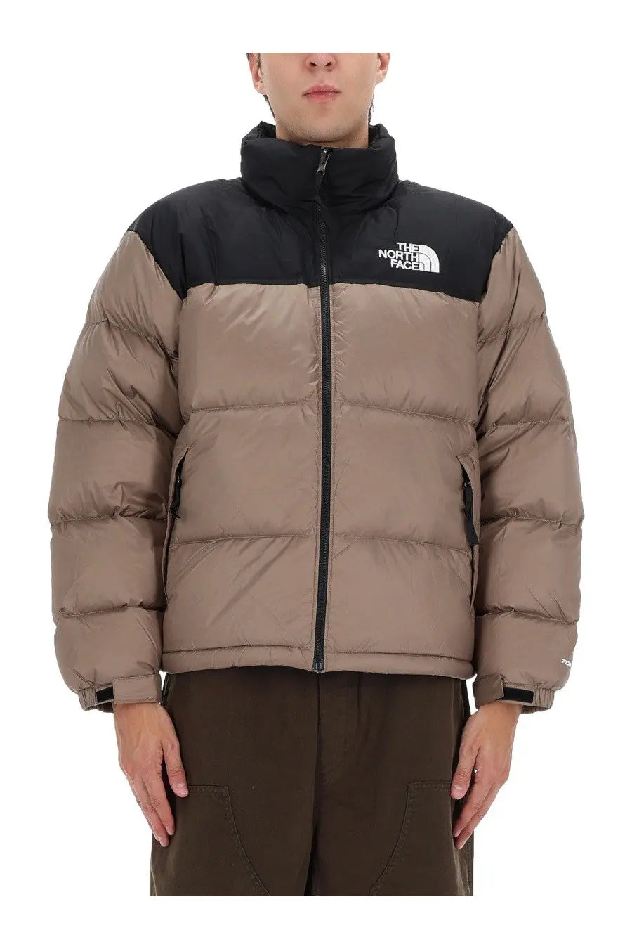 The north face men’s retro nuptse jacket in brown features a tan and black quilted puffer design for warmth