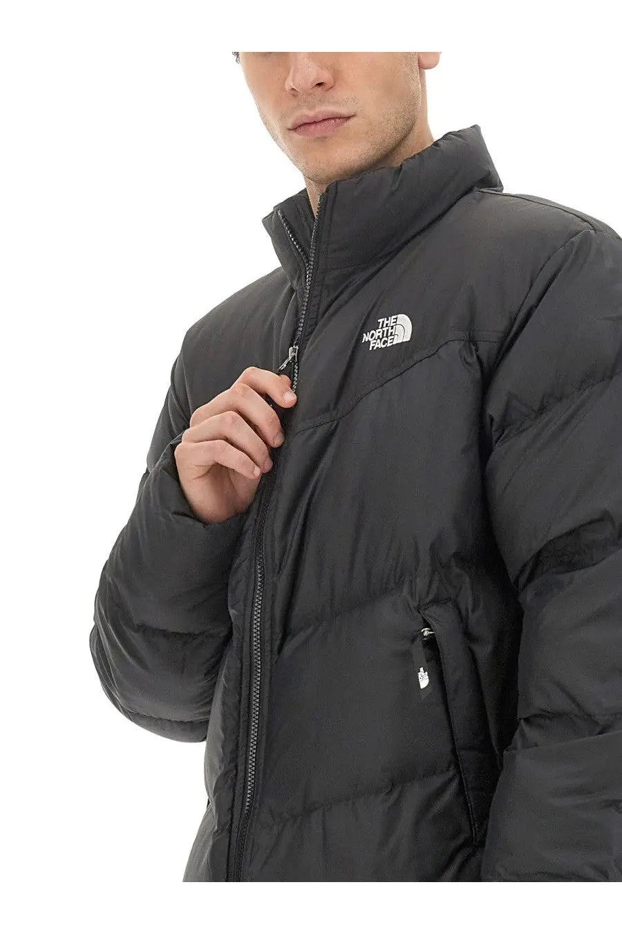 The North Face men’s Saikuru black puffer jacket with high collar and front zipper featuring logo on the chest