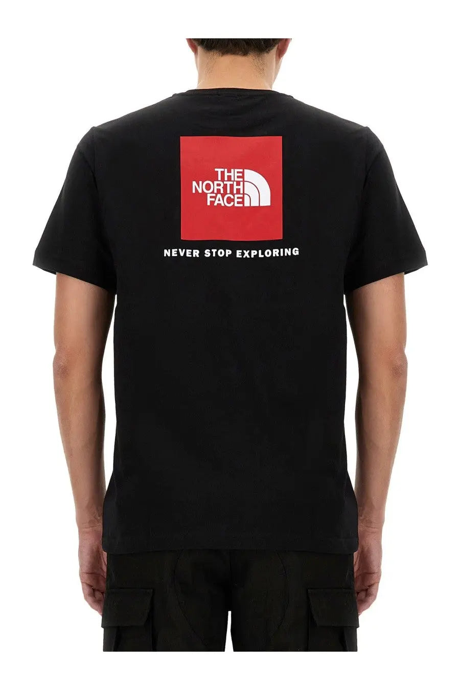 The North Face men’s black short-sleeved shirt features a bold red square logo and never stop exploring text