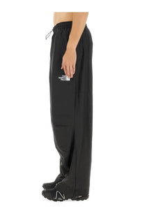 The North Face men’s wind track pants in black with a white logo on the thigh and an elastic waistband