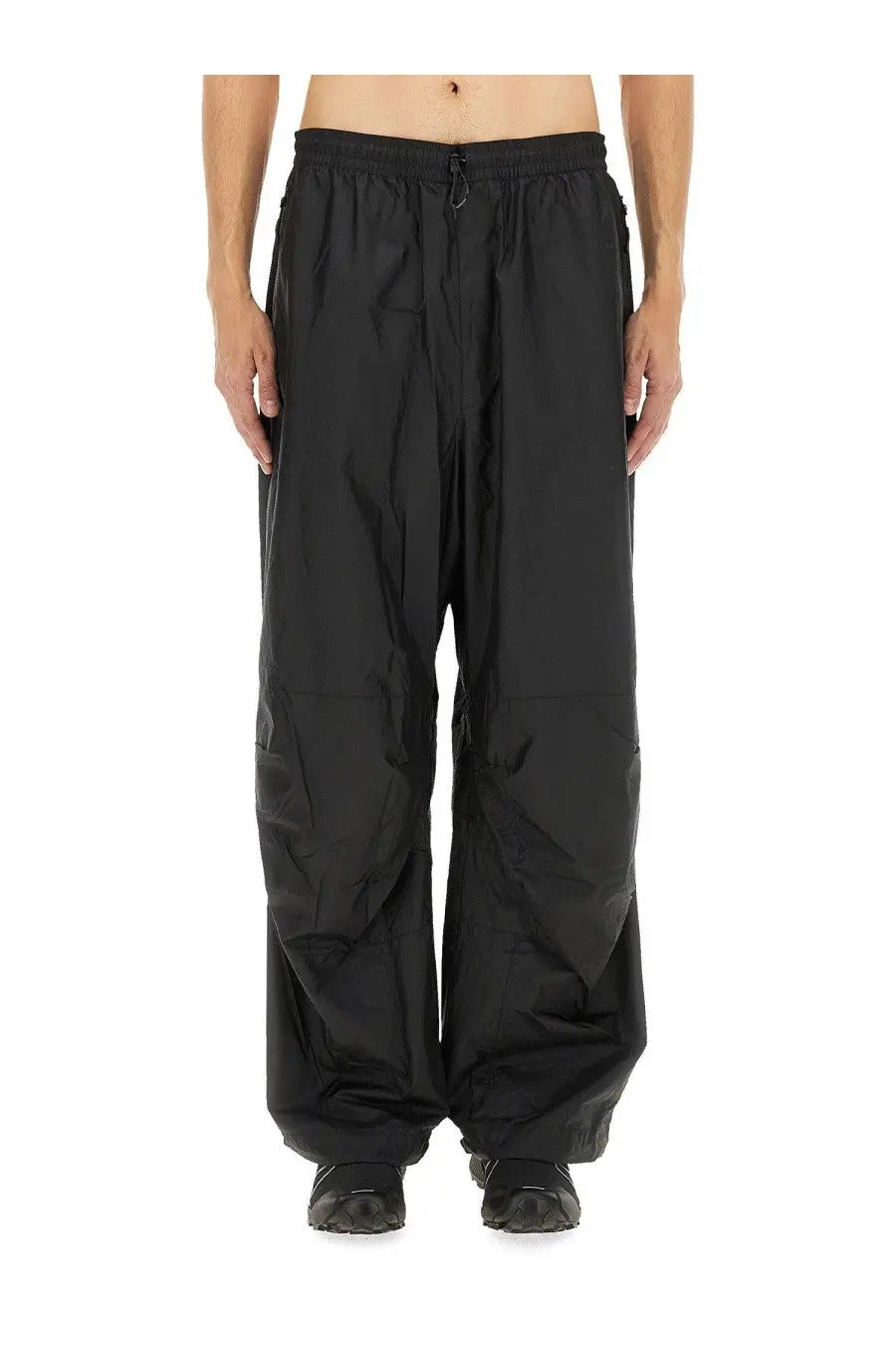 The North Face men’s wind track pant in black with wide-leg fit drawstring waist and subtle paneling
