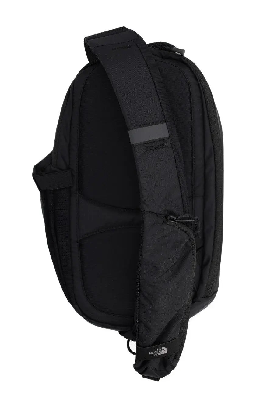 The north face unisex backpack borealis sling black with sleek minimalist design and gray reflective strip on shoulder strap