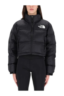 The North Face women’s black Nuptse jacket is a puffer with a high collar front zipper and logo on the chest