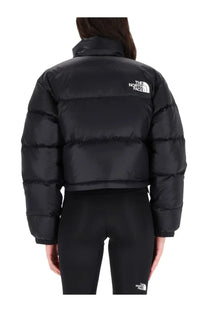 The back of The North Face women’s black Nuptse jacket featuring a quilted puffer design with a white logo