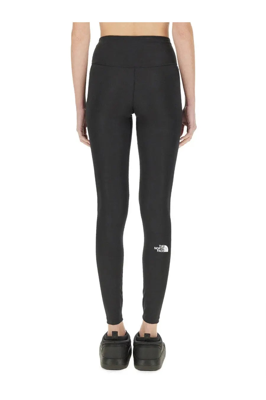 The north face women’s black high-waisted leggings with logo on the lower left leg made from stretchy material