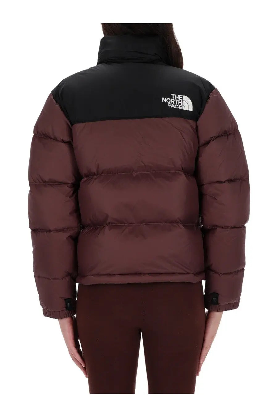 The north face women’s retro nuptse puffer jacket in burgundy with black shoulders and logo visible on the back