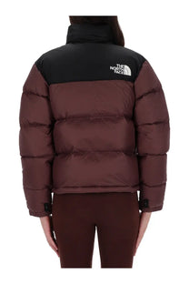 The north face women’s retro nuptse puffer jacket in burgundy with black shoulders and logo visible on the back