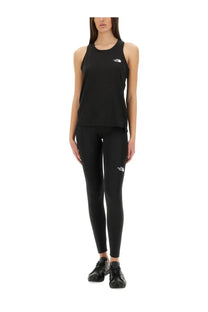 The North Face women’s black tank top and leggings set features a sleek fit with subtle white logos on chest and thigh