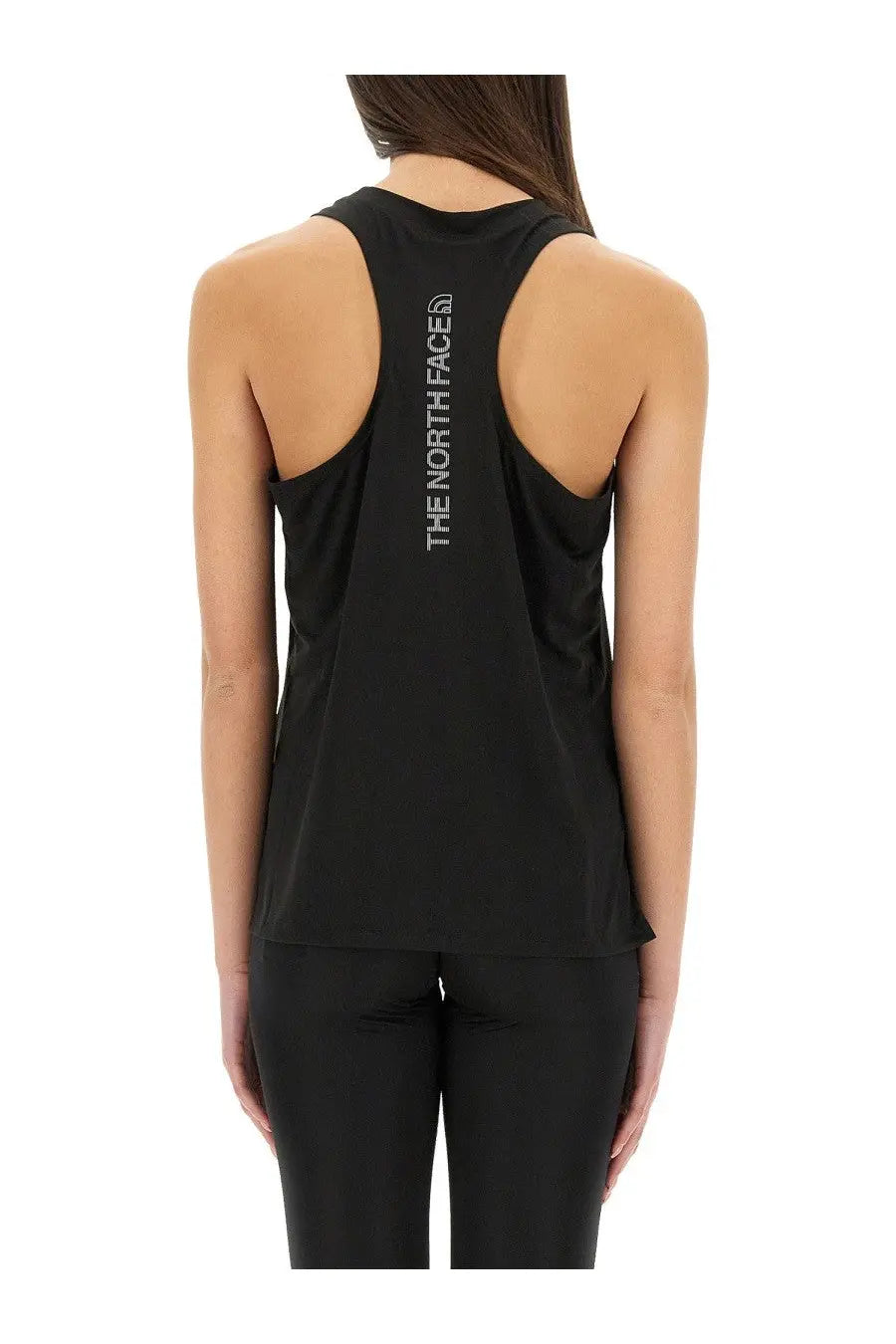 The North Face women’s black tank top with racerback design and vertical white logo on the back side